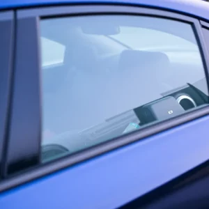 Interior of a parked car showing unsecured belongings