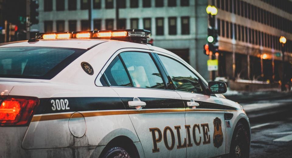 Marked police cruiser parked along a city street